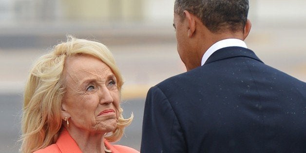 US President Barack Obama chats with Arizona Governor Jan Brewer (L) upon arrival at Phoenix International Airport on August