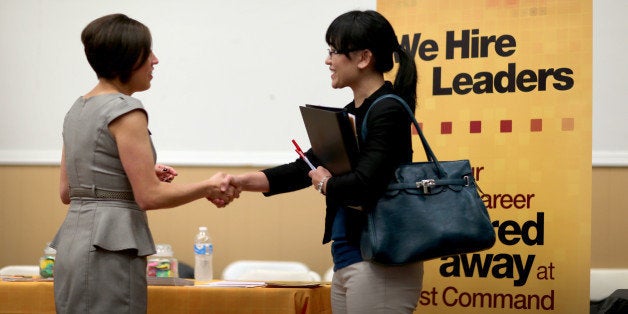 MIAMI, FL - OCTOBER 22: Melinda Walker (R) shakes hands with Angelina Tennis, who is recruiting for jobs at First Command Fin