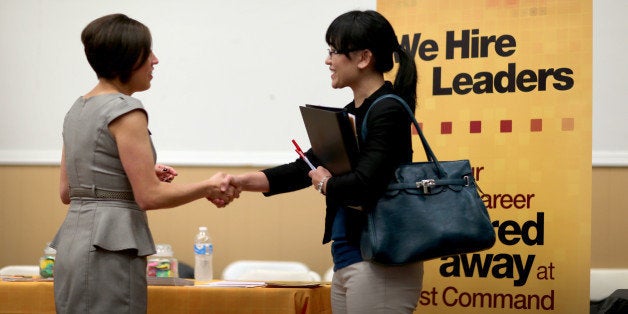 MIAMI, FL - OCTOBER 22: Melinda Walker (R) shakes hands with Angelina Tennis, who is recruiting for jobs at First Command Financial Services during a job fair for veteran job seekers at the Harvey W. Seed American Legion Post 29 on October 22, 2013 in Miami, Florida. The Labor Department announced today that employers added 148,000 jobs in September, lengthening a summer slowdown in payroll growth. The unemployment rate fell to 7.2 percent from 7.3 percent. (Photo by Joe Raedle/Getty Images)