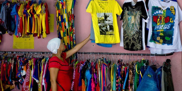 A client looks for clothes in a privately-owned shop in Havana, on October 4, 2013. Cuban Labor Vice Minister Marta Elena Feito said Tuesday that the private traders who sell imported goods will be fined. AFP PHOTO/Yamil LAGE (Photo credit should read YAMIL LAGE/AFP/Getty Images)