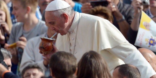 Pope Francis drinks 'mate' - traditional South American infused drink - as he arrives for his general audience at St Peter's square on October 30, 2013 at the Vatican. AFP PHOTO / GABRIEL BOUYS (Photo credit should read GABRIEL BOUYS/AFP/Getty Images)