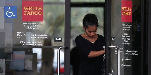 DALY CITY, CA - JULY 12: A customer leaves a Wells Fargo Bank branch office on July 12, 2012 in Daly City, California. The Justice Department announced Thursday that Wells Fargo Bank, the largest residential home mortgage originator in the United States, will pay nearly $175 million to settle accusations of discrimination against qualified African-American and Hispanic borrowers between 2004 and 2009. The alleged discrimination is in violation of fair-lending laws. (Photo by Justin Sullivan/Getty Images)