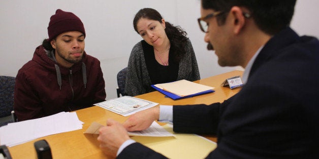 NEW YORK, NY - JANUARY 31: Immigration lawyer Andres Lemons advises Angel and Evie Gomez on their U.S. citizenship applicati