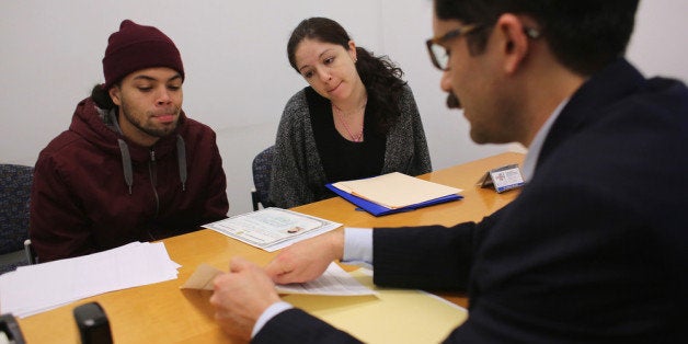 NEW YORK, NY - JANUARY 31: Immigration lawyer Andres Lemons advises Angel and Evie Gomez on their U.S. citizenship application on January 31, 2013 in New York City. The married couple, he from the Dominican Republic, and she from Canada are soon to have a baby and are working through the long process to become U.S. citizens. Lemons works at the CUNY Citizenship Now 'Express Center' in New York's Washington Heights. The non-profit helps some 8,000 immigrants in the New York area navigate through the complicated process of acquiring U.S. Citizenship and provides free legal information for the immigrant community. (Photo by John Moore/Getty Images)