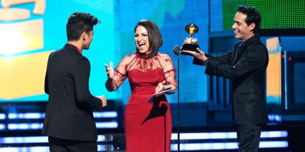 LOS ANGELES, CA - JANUARY 26: (L-R) Musician Bruno Mars accepts the Best Pop Vocal Album award for 'Unorthodox Jukebox' from singers Gloria Estefan and Marc Anthony onstage during the 56th GRAMMY Awards at Staples Center on January 26, 2014 in Los Angeles, California. (Photo by Kevork Djansezian/Getty Images)