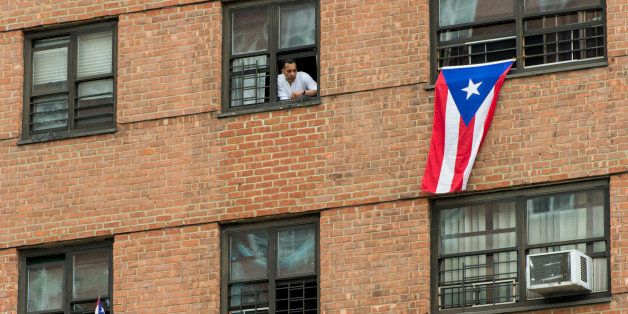 UNITED STATES - JUNE 9: Puerto Rican flags hang from windows at the Annual 116th Street Festival, billed as the largest Latin festival in the northeast, in East Harlem on Saturday, June 9, 2012. Espaillat, spoke to the crowd of thousands and waded into the crowd to shake hands. His opponent, Rep. Charlie Rangel, D-NY, was scheduled to speak at the festival, but did not show up. (Photo By Bill Clark/CQ Roll Call)