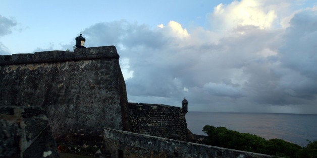 SAN JUAN, PUERTO RICO- APRIL 26: Stone walls surround the Castillo de San Felipe del Morro April 26, 2004 in Old San Juan, the original capital city of San Juan, Puerto Rico. Begun in the early 16th century, El Morro was the city's primary protection against sea attacks.The old city is a historic district of seven square blocks made up of ancient buildings and colonial homes, massive stone walls and vast fortifications, sunny parks and cobblestoned streets. (Photo by Joe Raedle/Getty Images)