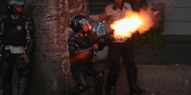 CARACAS, VENEZUELA - MARCH 06: Venezuelan national police fire tear gas at anti-government protesters on March 6, 2014 in Caracas, Venezuela. Three weeks of protests against the federal government have shaken the country as business in much of the nation has come to a standstill. (Photo by John Moore/Getty Images)