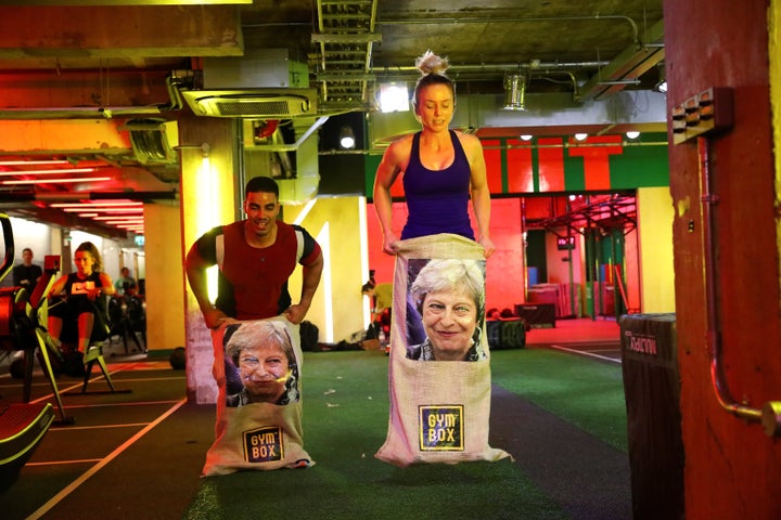 Gym members jump in sacks containing an image of Britain's Prime Minister Theresa May during a Brexfit gym class.