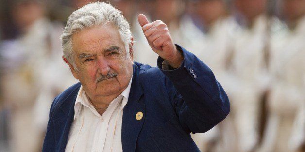 Uruguay's president Jose Mujica gives his thumb up at the press upon his arrival at La Moneda presidential palace in Santiago, on March 10, 2014. Four years after leaving Chile's presidency, Socialist Michelle Bachelet takes the oath of office for a second time on March 11, vowing to work to shrink the gap between rich and poor. Bachelet is to be sworn in on Tuesday in Valparaiso, city 120 km west of the Chilean capital. AFP PHOTO / CLAUDIO REYES (Photo credit should read Claudio Reyes/AFP/Getty Images)