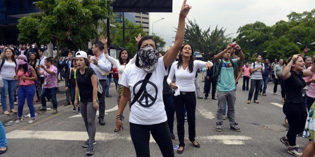 Opposition students protest in Caracas on May 8, 2014. Venezuelan authorities demolished four protest camps and detained 243 people early Thursday, striking at the remaining bastions of a months-long and at times deadly anti-government protest movement. AFP PHOTO/Geraldo Caso (Photo credit should read GERALDO CASO/AFP/Getty Images)