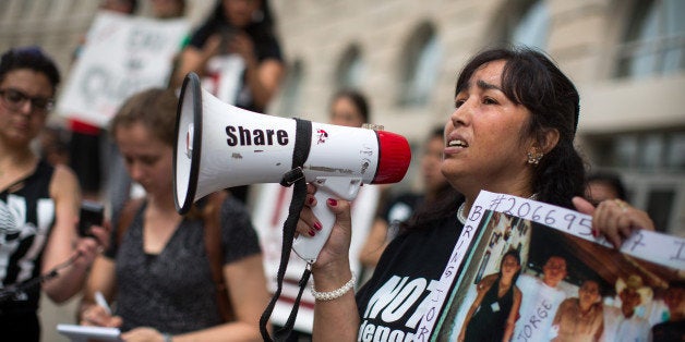 WASHINGTON, DC - MAY 9, 2014: Bertha Avila of El Salvador speaks to protesters in front of the U.S. Customs and Border Protection office housed in the Ronald Reagan building May 9, 2014 in Washington D.C. Demonstrators marched from the National Mall to the White House to protest the Congressional appropriations legislation that provides funds to the Department of Homeland Security to maintain 34,000 detainees for deportation. Five of the protesters were arrested in front of the White House for failing to vacate the area when warned by security. (Photo by Allison Shelley/Getty Images)