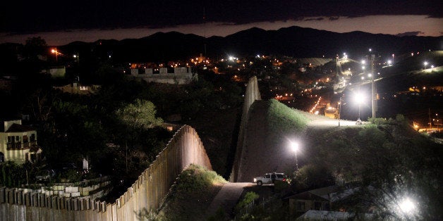 NOGALES, AZ - JULY 6: The border wall is illuminated at night July 6, 2012 in Nogales, Arizona. The president-elect of Mexic