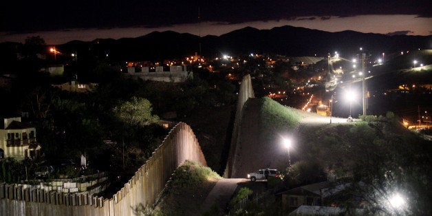 NOGALES, AZ - JULY 6: The border wall is illuminated at night July 6, 2012 in Nogales, Arizona. The president-elect of Mexico, Enrique PeÃ±a Nieto, stated that he wants to expand his country's drug-war partnership with the United States but that he would not support the presence of armed American agents in Mexico. (Photo by Sandy Huffaker/Getty Images)