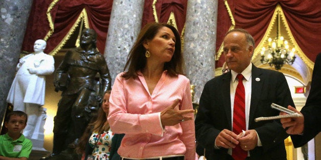 WASHINGTON, DC - AUGUST 01: U.S. Rep. Steve King (R-IA) (R) and Rep. Michele Bachmann (R-MN) (2nd R) pass through the Statuary Hall after a vote on the floor August 1, 2014 on Capitol Hill in Washington, DC. The House came back on Friday, a day after its scheduled summer recess, trying to finish up a border supplemental spending bill that was pulled from the floor the day before because of a shortage of votes. (Photo by Alex Wong/Getty Images)