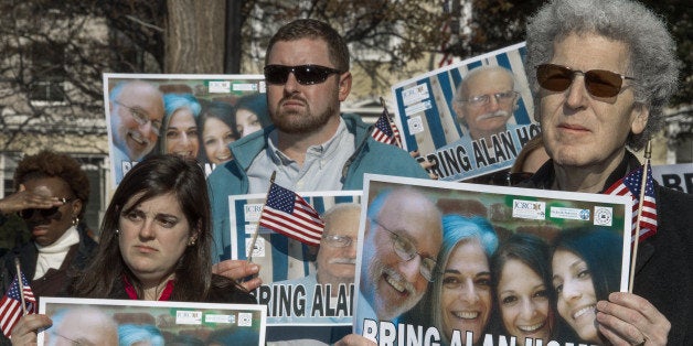 Supporters rally on behalf of imprisioned US citizen Alan Gross, calling for US President Barack Obama to help free Gross, who has been in a Cuban prison for 4 years, during a rally in Lafayette Park December 3, 2013, across the street from the White House, in Washington, DC. AFP PHOTO/Paul J. Richards (Photo credit should read PAUL J. RICHARDS/AFP/Getty Images)