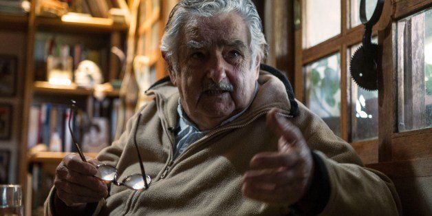 Uruguayan President Jose Mujica gestures during an interview with Agence France-Presse at his house, on the outskirts of Montevideo on July 9, 2014. Mujica told AFP Wednesday that sales of marijuana will be delayed until next year because of difficulties in implementing the controversial law legalizing the drug. The South American country in December became the first in the world to announce that it would regulate the market for cannabis and its derivatives, a bold move by authorities frustrated with losing resources to fighting drug trafficking. Direct marijuana sales to consumers will 'go to next year,' Mujica, 79, said in an interview with AFP. 'There are practical difficulties.' AFP PHOTO / Daniel CASELLI (Photo credit should read DANIEL CASELLI/AFP/Getty Images)