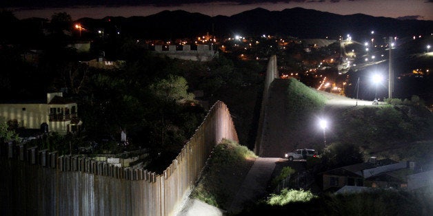 NOGALES, AZ - JULY 6: The border wall is illuminated at night July 6, 2012 in Nogales, Arizona. The president-elect of Mexico, Enrique PeÃ±a Nieto, stated that he wants to expand his country's drug-war partnership with the United States but that he would not support the presence of armed American agents in Mexico. (Photo by Sandy Huffaker/Getty Images)