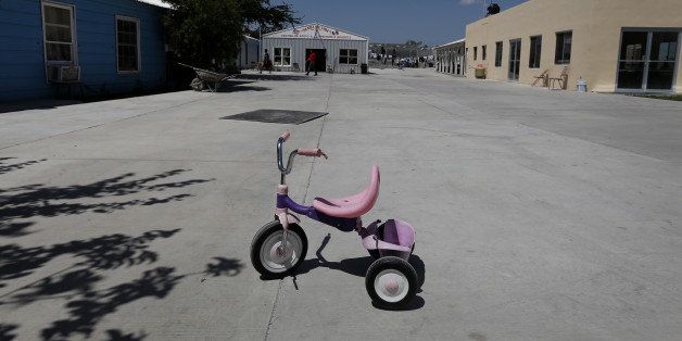 A child's tricycle stands in the court yard of the Senda de Vida shelter in Reynosa, Mexico, on Tuesday, June 17, 2014. More than 47,000 unaccompanied minors have crossed the border since October, a 92 percent increase from the prior year, according to U.S. Customs and Border Protection. They're part of a surge of immigrants, mainly Central American, fleeing violence and poverty after hearing that immigration policy has grown more accommodating. Photographer: Tochiro Gallegos/Bloomberg via Getty Images
