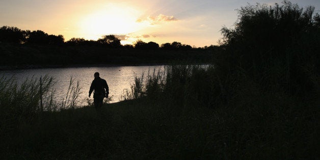 MCALLEN, TX - SEPTEMBER 08: A U.S. Border Patrol agent inspects the bank of the Rio Grande River across from Mexico on September 8, 2014 near McAllen, Texas. Although the numbers immigrant families and unaccompanied minors crossing illegally into the area have decreased from a springtime high, thousands continue to cross the border illegally into the United States. Texas' Rio Grande Valley area is the busiest sector for illegal border crossings, especially for Central Americans, into the U.S. (Photo by John Moore/Getty Images)