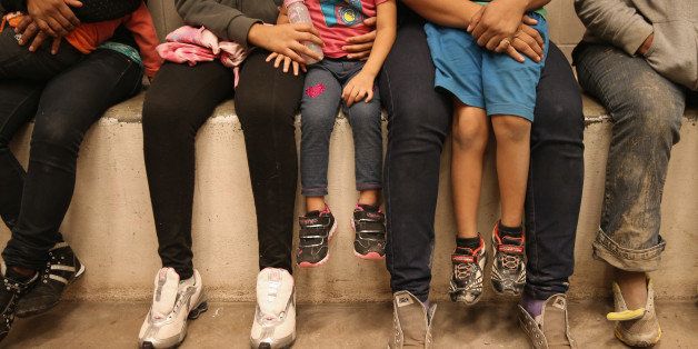 MCALLEN, TX - SEPTEMBER 08: Women and children sit in a holding cell at a U.S. Border Patrol processing center after being detained by agents near the U.S.-Mexico border on September 8, 2014 near McAllen, Texas. Thousands of immigrants, many of them families and unaccompanied minors, continue to cross illegally into the United States, although the numbers are down from a springtime high. Texas' Rio Grande Valley area is the busiest sector for illegal border crossings into the United States. (Photo by John Moore/Getty Images)