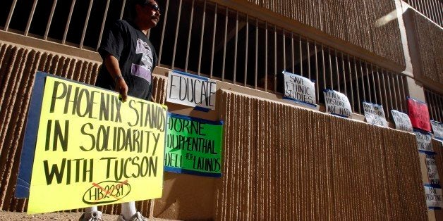 Juan Lopez, of Phoenix, show his support of the Tucson Unified School District, after Superintendent of Public Instruction John Huppenthal announces that the Tucson Unified School District violates state law by teaching it's Mexican American Studies Department's ethic studies program at a news conference at the Arizona Department of Education Wednesday, June 15, 2011, in Phoenix. (AP Photo/Ross D. Franklin)