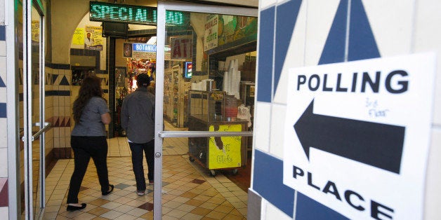 LOS ANGELES, CA - NOVEMBER 6: A directional sign points the way to a polling place inside El Mercado de Los Angeles, a Mexico-style marketplace in the heavily Latino East L.A. area, during the U.S. presidential election on November 6, 2012 in Los Angeles, California. The election will decide whether Democrat Barack Obama serves a second term as president of the United States or is replaced by Republican rival, former Massachusetts Gov. Mitt Romney. (Photo by David McNew/Getty Images)