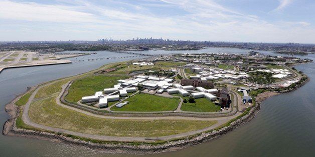 This June 20, 2014, aerial photo shows New York's biggest lockup, Riker's Island jail, with the New York skyline in the background. Investigative documents obtained by The Associated Press on the 11 suicides in New York City jails over the past five years show that in at least nine cases, protocols and safeguards designed to prevent inmates from harming themselves were not followed. (AP Photo/Seth Wenig)