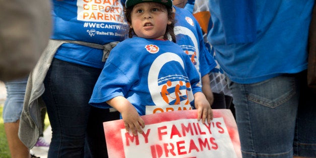 Miguel Nunez holds a sign demanding immigration reform in Deerfield Beach, Fla, Wednesday, Aug. 20, 2014. Seven people from t