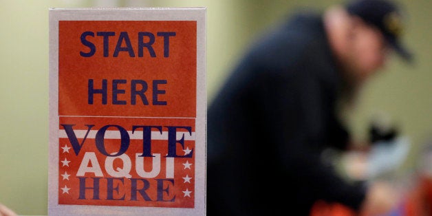 In this Wednesday, Feb. 26, 2014 photo, a voter prepares to cast his ballot at an early voting polling site, in Austin, Texas. In elections that begin next week, voters in 10 states will be required to present photo identification before casting ballots _ the first major test of voter ID laws after years of legal challenges arguing that the measures are designed to suppress voting. (AP Photo/Eric Gay)