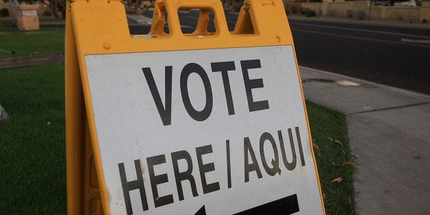 PHOENIX - NOVEMBER 4: A bilingual sign announces a polling place in the home state of Republican presidential nominee U.S. Sen. John McCain (R-AZ) November 4, 2008 in Phoenix, Arizona. Voting is underway in the U.S. presidential elections with Democratic presidential nominee Sen. Barack Obama (D-IL) leading in the polls against the Republican presidential nominee Sen. John McCain (R-AZ). (Photo by David McNew/Getty Images)