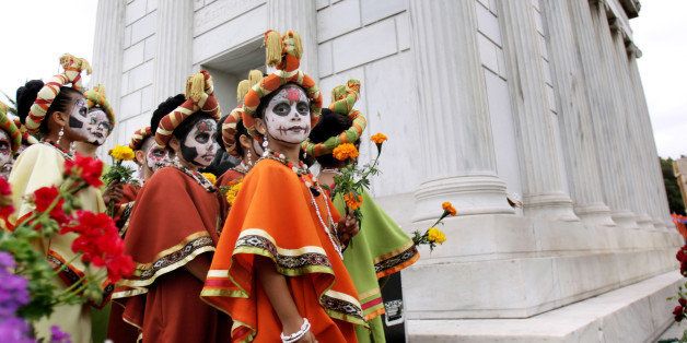 A group of young girls prepare for a performance while taking part in the Dia de los Muertos (Day of the Dead) festivities at the Hollywood Forever Cemetery in the Hollywood section of Los Angeles on Saturday Nov.1,2008. It's an ancient Mexican tradition to commemorate the dead, that year after year attracts more tourists to a cemetery that comes alive only for one night (AP Photo/Richard Vogel)
