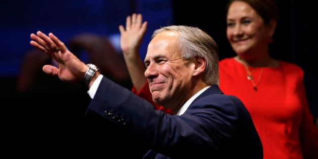 Texas Attorney General and Republican candidate for governor Greg Abbott waves to the crows before his victory speech Tuesday, Nov. 4, 2014, in Austin, Texas. Abbott defeated Democrat Wendy Davis to win the race for Texas governor. (AP Photo/David J. Phillip)