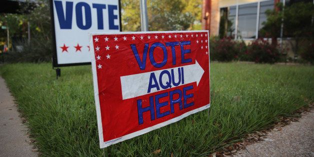 AUSTIN, TX - APRIL 28: A bilingual sign stands outside a polling center at public library ahead of local elections on April 28, 2013 in Austin, Texas. Early voting was due to begin Monday ahead of May 11 statewide county elections. The Democratic and Republican parties are vying for the Latino vote nationwide following President Obama's landslide victory among Hispanic voters in the 2012 election. (Photo by John Moore/Getty Images)