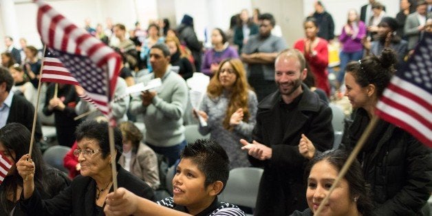 NEW YORK, NY - NOVEMBER 20: Teresa Galindo (L) her grandson Daniel Cuenca and daughter Yanet Cuenca wave flags at the offices of 32BJ SEIU, a workers union, during a viewing party for U.S. President Barack Obama's speech on evecutive action immigration policy reform on November 20, 2014 in New York City. In his announcement, the president detailed his plans to take executive action to provide administrative relief to millions of immigrants. (Photo by Kevin Hagen/Getty Images)