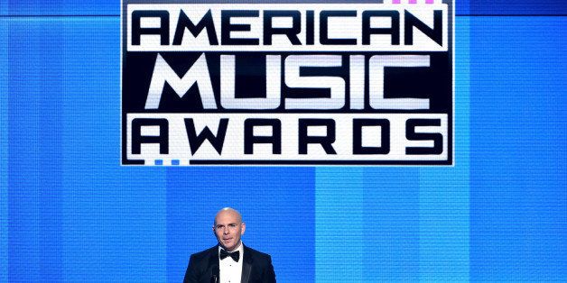 LOS ANGELES, CA - NOVEMBER 23: Host Pitbull speaks onstage at the 2014 American Music Awards at Nokia Theatre L.A. Live on November 23, 2014 in Los Angeles, California. (Photo by Kevin Winter/Getty Images)