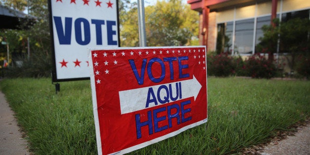 AUSTIN, TX - APRIL 28: A bilingual sign stands outside a polling center at public library ahead of local elections on April