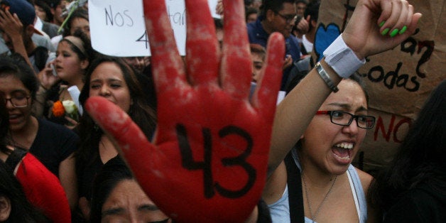 In this Oct. 22, 2014 photo, pepole protest the disappearance of 43 students in Mexico City. On Sept. 26, students from the R