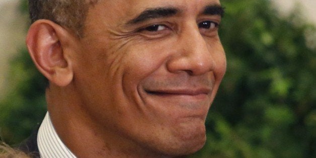 US President Barack Obama smiles at as he awards the Medal of Honor to Army First Lieutenant Alonzo Cushing, given to relativ