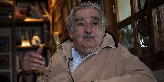 Uruguayan President Jose Mujica speaks during an interview with Agence France-Presse at his house, on the outskirts of Montevideo on July 9, 2014. Mujica told AFP Wednesday that sales of marijuana will be delayed until next year because of difficulties in implementing the controversial law legalizing the drug. The South American country in December became the first in the world to announce that it would regulate the market for cannabis and its derivatives, a bold move by authorities frustrated with losing resources to fighting drug trafficking. Direct marijuana sales to consumers will 'go to next year,' Mujica, 79, said in an interview with AFP. 'There are practical difficulties.' AFP PHOTO / Daniel CASELLI (Photo credit should read DANIEL CASELLI/AFP/Getty Images)