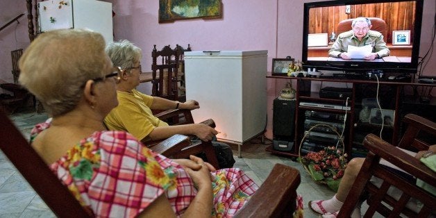 Cubans watch Cuban president Raul Castro on TV while he addresses the country, on December 17, 2014 in Havana. Castro said th