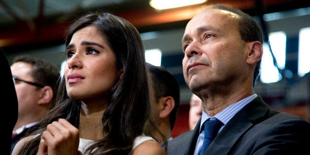 Actress Diane Guerrero and Rep. Luis Gutierrez, D-Ill., listens as President Barack Obama speaks about immigration at Del Sol High School, in Las Vegas, Friday, Nov. 21, 2014. The president unveiled expansive executive actions on immigration Thursday night to spare millions people in the U.S. illegally from deportation, setting off a fierce fight with Republicans over the limits of presidential powers. (AP Photo/Carolyn Kaster)