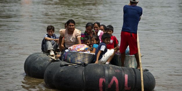 People from Central America in a rubber raft illegally cross the Suchiate river from Guatemala into bordering Mexico, to the lawless outskirts of the city of Ciudad Hidalgo, in Chiapas State, on April 8, 2011. Every day and for less than a US dollar, hundreds of people from Central American nations cross into southern Mexico with the intention of reaching the United States further north. Others make the two-way crossing for smuggling goods -- basic necessity items are taken from Mexico to Guatemala and vegetables, flowes and migrants go in the other direction. AFP PHOTO/RONALDO SCHEMIDT (Photo credit should read Ronaldo Schemidt/AFP/Getty Images)