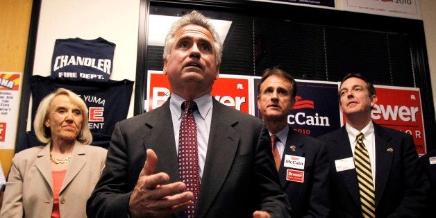 In this Aug. 26, 2010 photo, Republican candidate for state superintendent of public instruction John Huppenthal, front, talks to the party faithful at Sen. John McCain's campaign headquarters in Phoenix. Behind Huppenthal are Gov. Jan Brewer, left, Gary Pierce, Republican candidate for Corporation Commission, and Ken Bennett, Republican candidate for Secretary of State, right. (AP Photo/Ross D. Franklin)