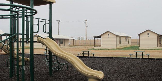 A playground surrounded by cottages that will house immigrants at a new family immigration detention center in Dilley, Texas, on Monday, Dec. 15, 2014. Opening following a summer surge of children crossing the U.S.-Mexico border illegally, the compound features cottages and will have an initial capacity of 480 growing to 2,400 around May _making it the nation's largest family immigration lockup. (AP Photo/Will Weissert)