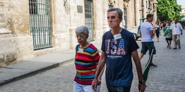 A Cuban wearing a t-shirt with the US flag walks along a street of Havana, on January 16, 2015. The United States will ease travel and trade restrictions with Cuba on Friday, marking the first concrete steps towards restoring normal ties with the Cold War-era foe since announcing a historic rapprochement. AFP PHOTO/YAMIL Lage (Photo credit should read YAMIL LAGE/AFP/Getty Images)