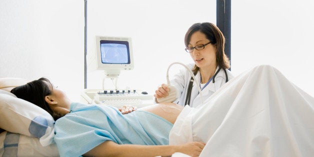 Pregnant woman having ultrasound scan