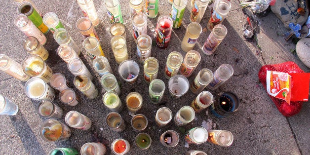 In this Feb. 18, 2015 photo, candles are shown at a memorial in Pasco, Wash., on the sidewalk where Antonio Zambrano-Montes, an unarmed man who was running away from police at a crowded intersection, fell after being fatally shot by police. (AP Photo/Nicholas K. Geranios)