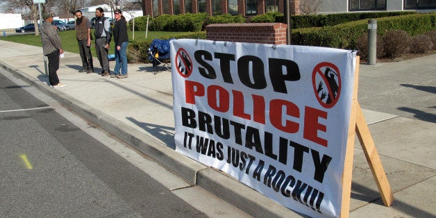 In this Feb. 18, 2015 photo, a protest sign is displayed in front of City Hall in Pasco, Wash., the city where Antonio Zambrano-Montes, an unarmed man who was running away from police at a crowded intersection, was fatally shot by police on Feb. 10, 2015. (AP Photo/Nicholas K. Geranios)