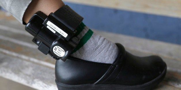 In this Monday, Sept. 23, 2013 photo, Belky Rubio shows her ankle monitor in Homestead, Fla. Rubio, who is an undocumented im
